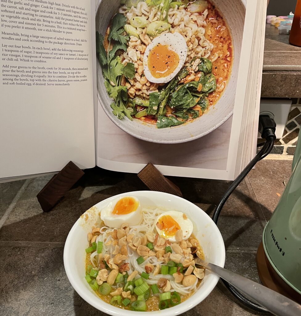 a glimpse at the carrot peanut ramen recipe next to the photo in the Tenderheart cookbook